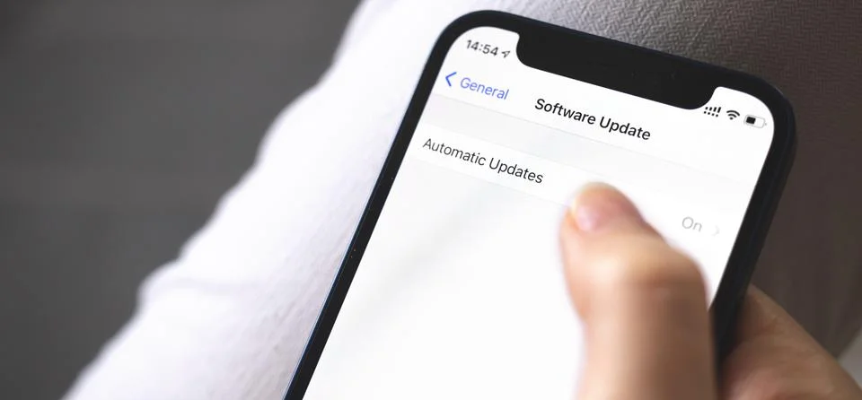 Software update screen on mobile phone close-up, automatic update button, ban Stock Photos