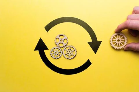 Software upgrade concept. The hand connects the mechanism with a gear. Stock Photos