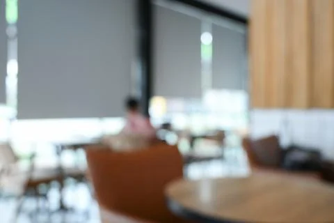 Softy blurred view of a modern cafe or lounge interior featuring comfortabl.. Stock Photos