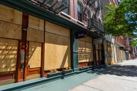 Soho district stores boarded up the windows at NEW YORK CITY. Stock Photos