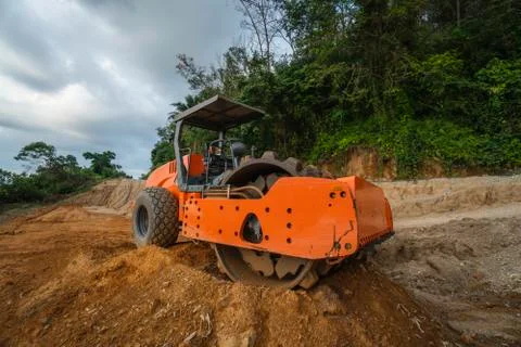 Soil compactor with vibratory padfoot drum. Heavy duty machinery working on Stock Photos