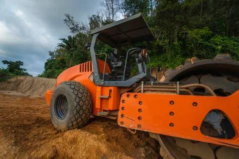 Soil compactor with vibratory padfoot drum. Heavy duty machinery working on Stock Photos