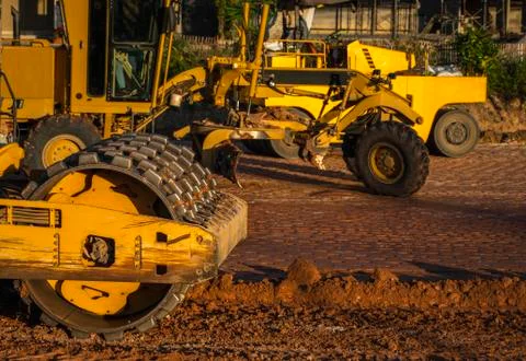 Soil compactor with vibratory padfoot drum. Heavy duty machinery working on Stock Photos
