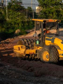 Soil compactor with vibratory padfoot drum. Heavy duty machinery working on Stock Photos
