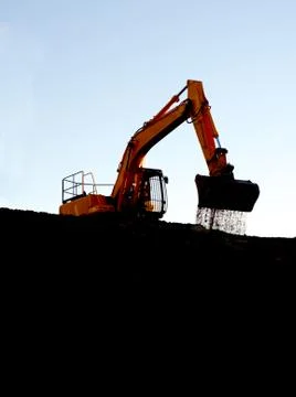 Soil falling from dozer bucket Stock Photos