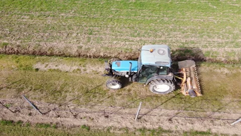 Soil milling between rows of a vineyard with tractor Stock Footage 149211341