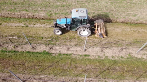 Soil milling between rows of a vineyard with tractor Stock Footage 149215381