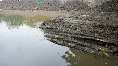 Soil pile material in construction industry, rainy day scene Stock Footage 94167435