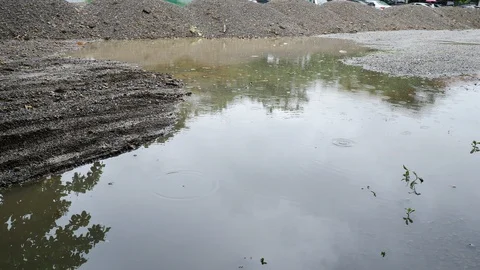 Soil pile material in construction industry, rainy day scene Stock Footage 98225498
