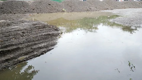 Soil pile material in construction industry, rainy day scene Stock Footage 113894299