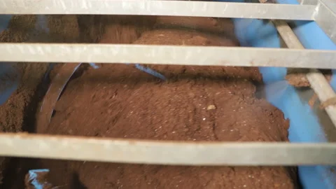 Soil preparation. A large mixer prepares fertilizers for seedlings Stock Footage 176846479
