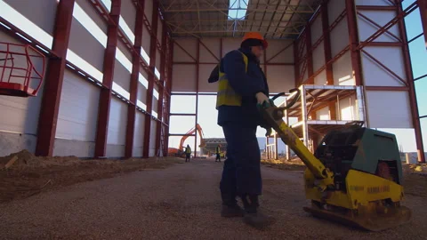 The soil rammer is compacting the sand cushion for the concrete floor, base   Stock Footage 161956936