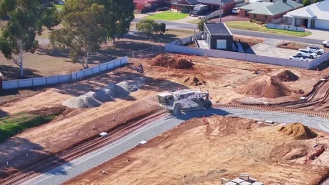 Soil stabiliser working around a bend in a new road on construction site Stock Footage 277968240