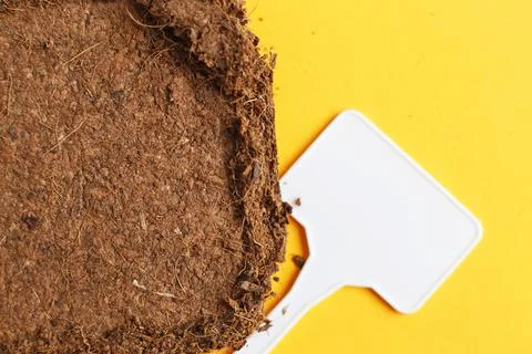 Soil texture close up. mock up. coconut briquette with writing boards on a or Fotos Stock