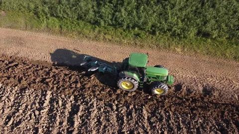 Soil tillage with tractor at sunset Stock-Footage 163206882