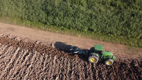 Soil tillage with tractor at sunset Stock Footage 163207856