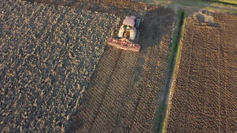 Soil tillage with tractor at sunset Stock-Footage 163219513