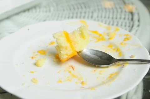 Soiled cake plates on rattan table Stock Photos