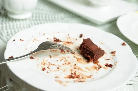 Soiled cake plates on rattan table Stock Photos