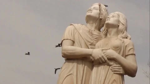 Soiled Marble Lover Statues Looking Skyward as Birds Fly By in Slow Motion Stock Footage 163262263