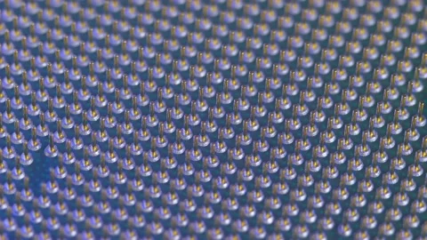 Soket pins on computer CPU processor in light of different colors Stock Footage 163000331