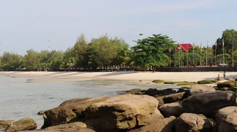 Sokha Beach flags white sand beach rocks pan to bay tight Stock Footage 50416510