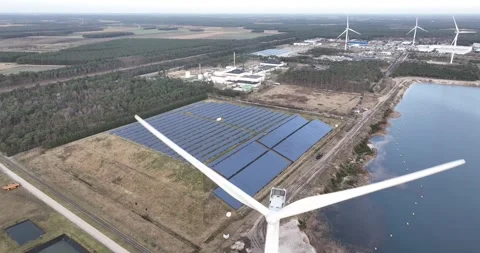 Solar and wind energy generation at industrial zone in Belgium. Next to a Stock Footage 263874785