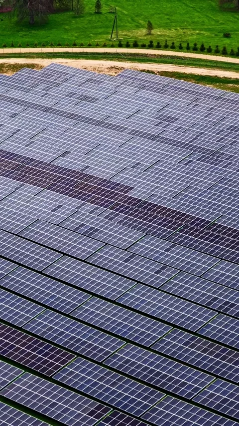 Solar Array Adjacent to Green Pastures and Rural Buildings Stock Footage 335210405