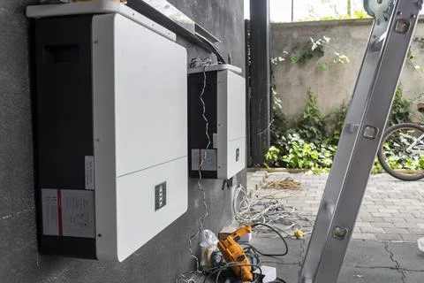 Solar battery installation with tools on floor and ladder in residential setup Stock Photos