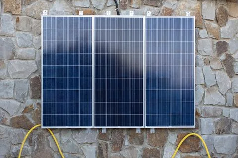 Solar battery system installed on wall of house. Three-section panel to accum Foto stock