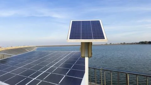 Solar cell panels installed to power a water pump at a reservoir. Stock Photos
