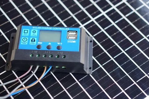 Solar charge controller with USB port connected by wires placed on photovoltaic  Stock Photos