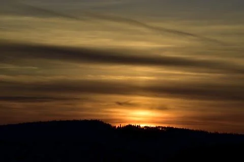 A solar disc in the clouds at an autumn sunset, visible in October from the V Stock Photos