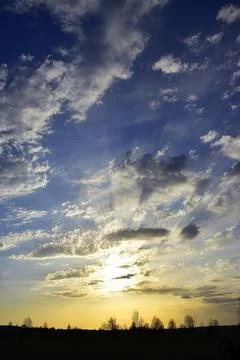 The solar disk sets in the clouds. Evening in the foothills of the Western Ur Stock Photos