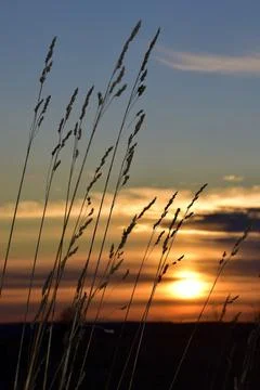 The solar disk sets in the clouds. Evening in the foothills of the Western Ur Stock Photos