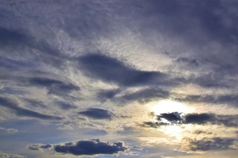 The solar disk sets in the clouds. Evening in the foothills of the Western Ur Stock Photos