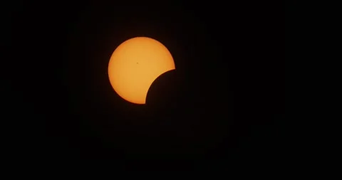 Solar eclipse with 10% disk coverage in the morning sky on April 8, 2024. Stock Footage 271658798
