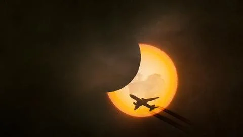 Solar eclipse with airplane Stock Photos