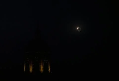 Solar Eclipse Behind a Church Tower Фото