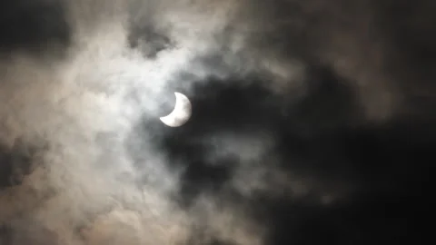 Solar eclipse, black clouds cover the moon Stock Footage 299108918