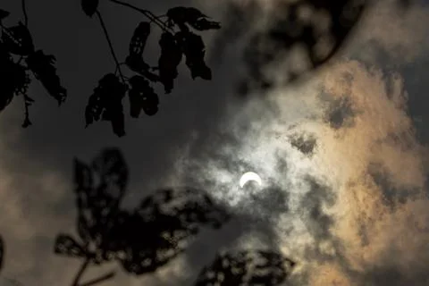 Solar Eclipse with Clouds in the Sky Stock Photos