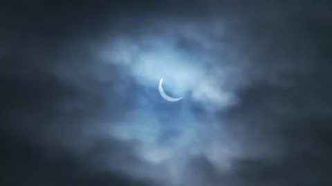 Solar Eclipse in a cloudy blue sky 2 Video stock 112511220