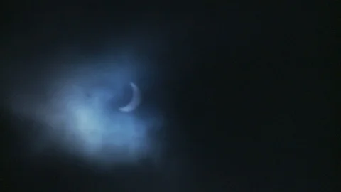 Solar Eclipse in a cloudy sky with exposure flicker and focus Stock Footage 112535211