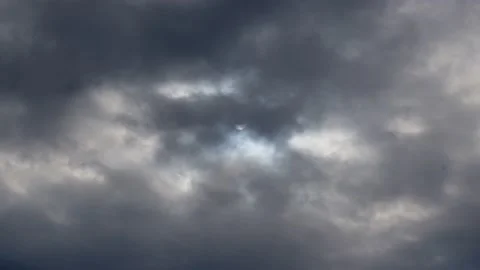 A solar eclipse in cloudy weather through a cloud. partial solar eclipse. Stock Footage 224373737