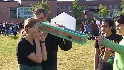 Solar eclipse on college campus and students with telescopes Stock Footage 78541039