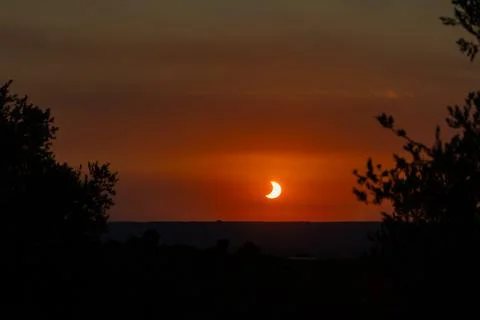 Solar eclipse creating crescent sun over Lleida, Spain Stock Photos