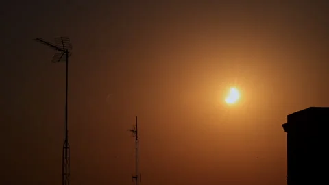 Solar Eclipse Crescent Madrid Rooftop TV Antennas Building Silhouette Dusk Stock Footage 347498829