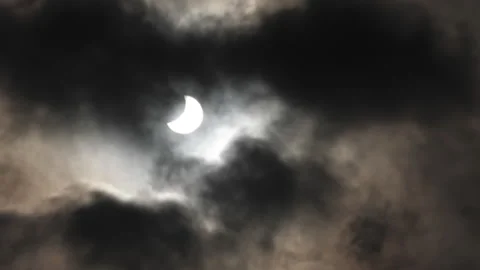 Solar eclipse in dark cloudy sky Stock Footage 240527689