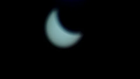 Solar eclipse in the Dubai desert. almost anular phase, full of the Stock Footage 135710781