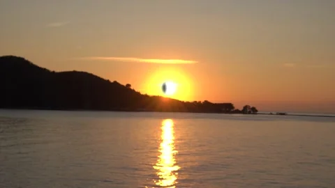 Solar eclipse during fascinating fiery sunset. Panorama of beautiful mountain 動画素材 147144073